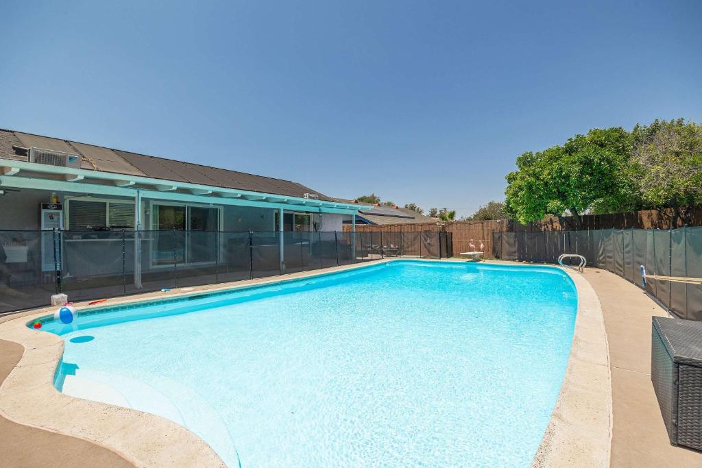 a large swimming pool in front of a house at Backyard Oasis Private Villa Pool Hot Tub in El Cajon