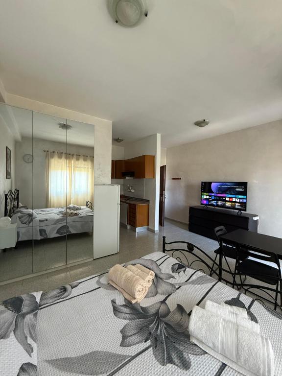 a living room with a bed and a tv at Residenza Anagnina in Rome