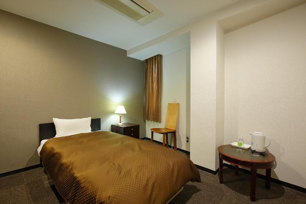 Posteľ alebo postele v izbe v ubytovaní Grampus Inn Osaka