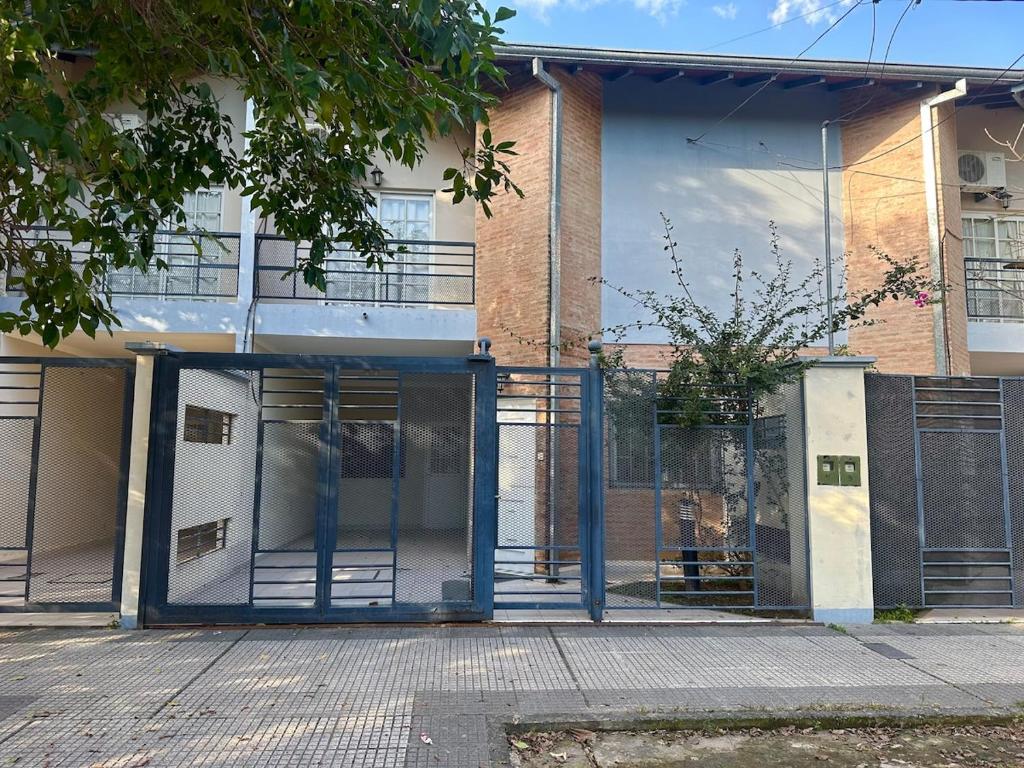 an entrance to a building with a glass door at Espacioso Departamento Céntrico in Formosa