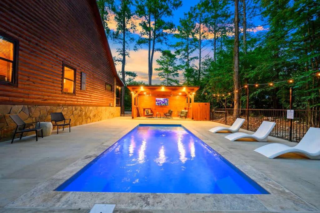 a swimming pool in the middle of a patio at After the Sunset 1-Level 5BR Pool - Arcade in Broken Bow