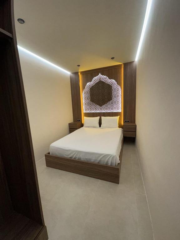 a bedroom with a white bed with a head board at STUDIO HIGH LuX 01 in Tangier