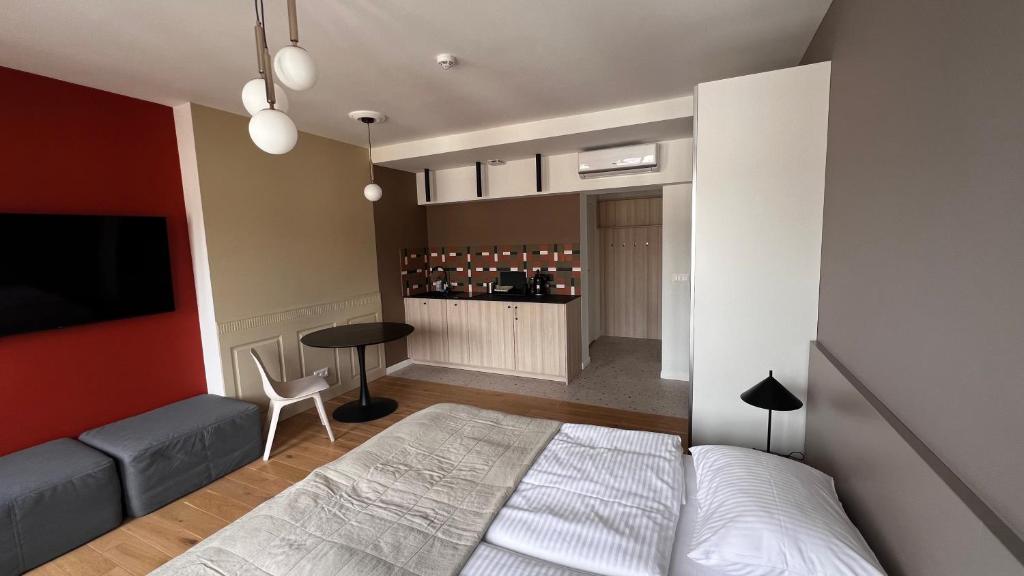 a bedroom with a bed and a couch and a table at Poziom Morza in Gdynia