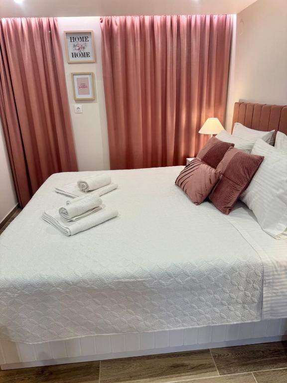 a bedroom with a bed with two towels on it at Lucky Home Chios in Chios
