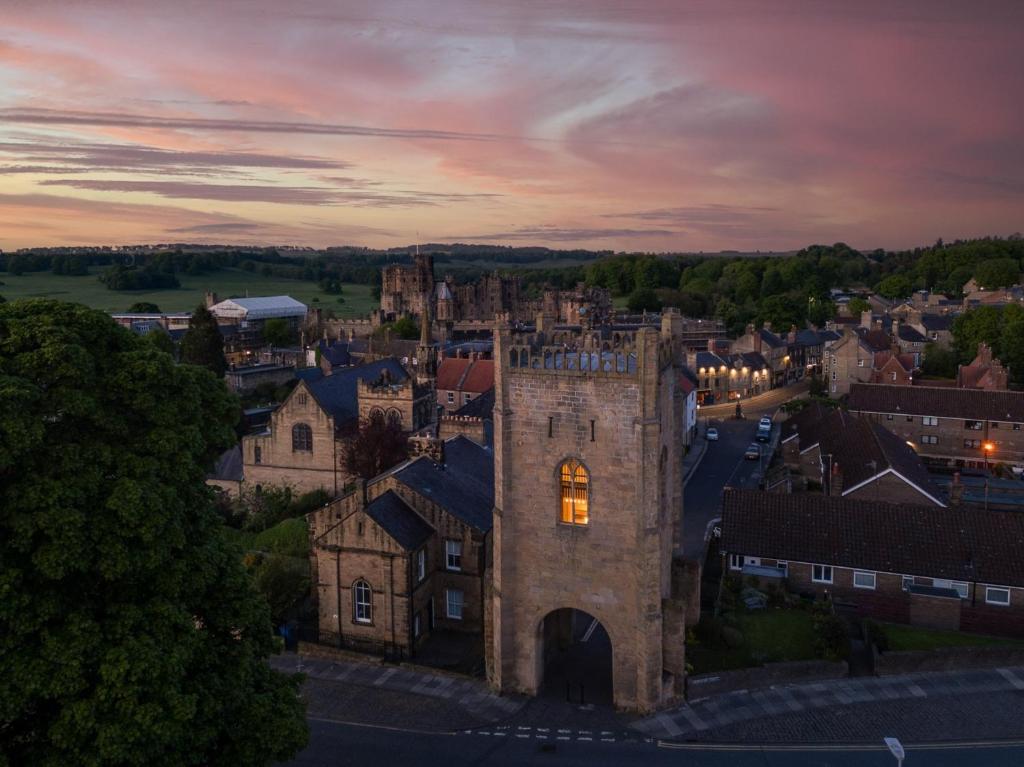 an old castle in a small town at sunset at 1 bed property in Alnwick 82212 in Alnwick