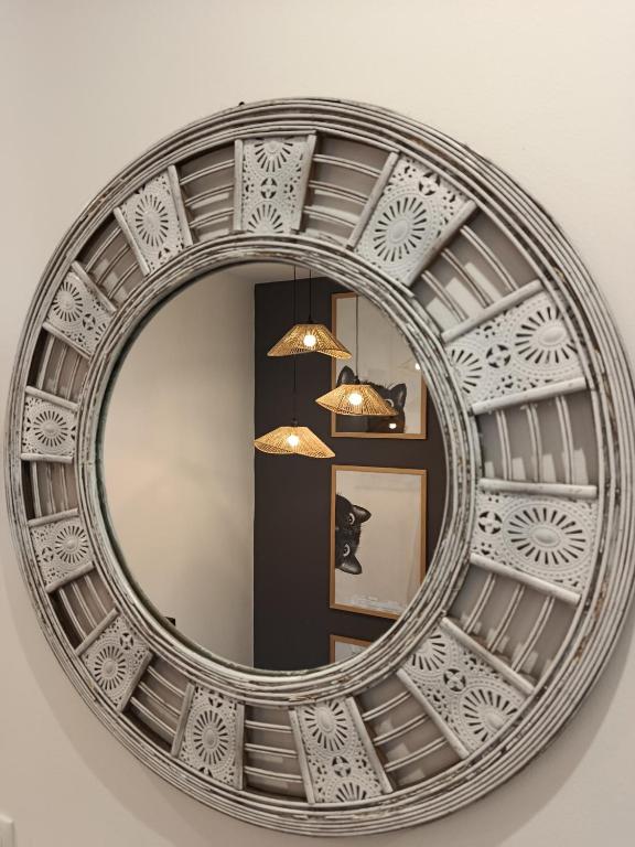 a circular mirror on a wall in a room at CatMandu Oldstation in Amarante