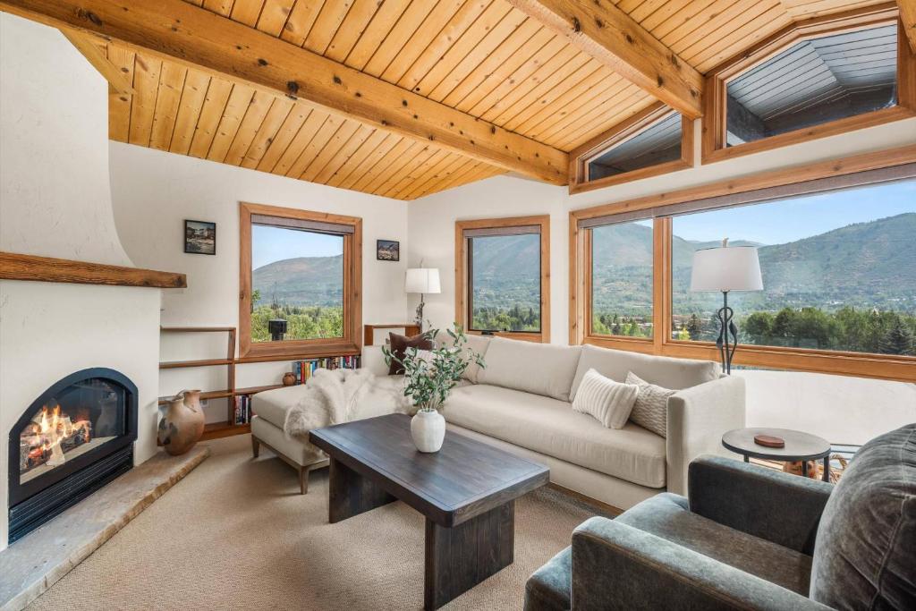 a living room with a couch and a fireplace at Shadow Mountain 10 in Aspen