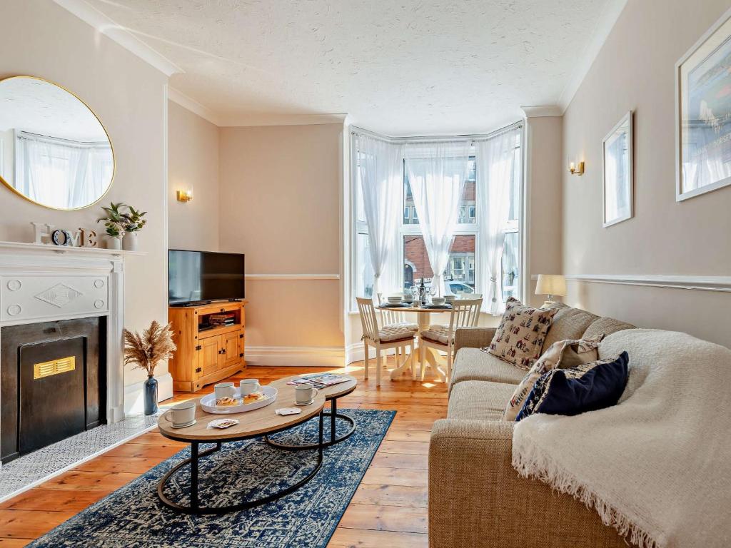 a living room with a couch and a table at 2 Bed in Swanage 90116 in Swanage