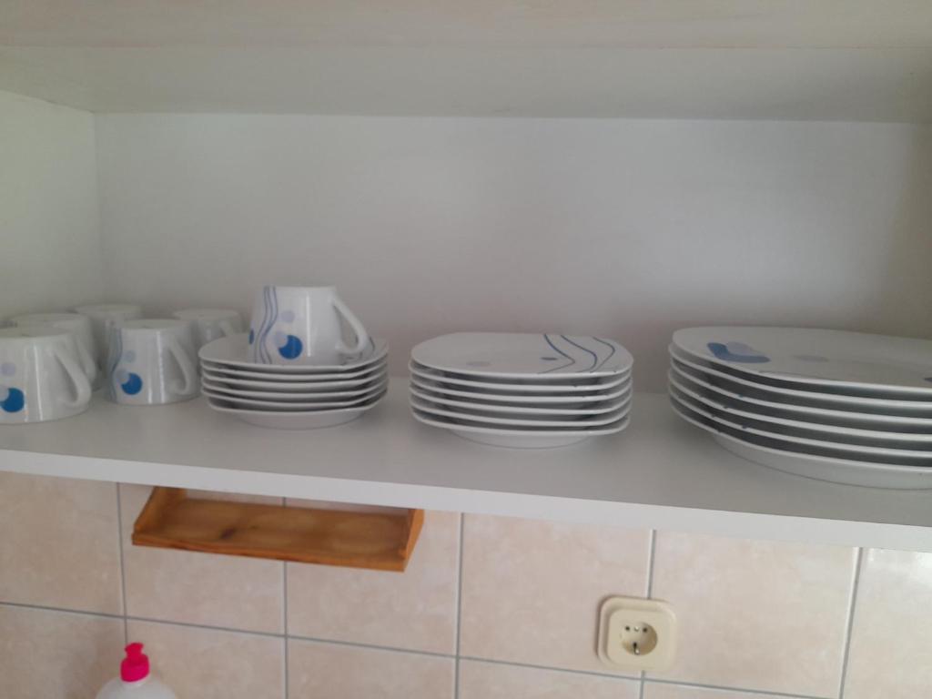 a shelf with plates and bowls on it at Ohrid in Ohrid