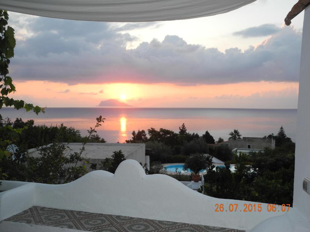 a sunset view from the balcony of a villa at Note di Salina in Santa Marina Salina