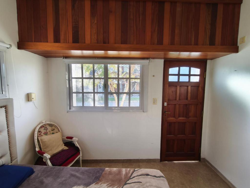 a bedroom with a bed and a window and a door at Hogar Argentina 2 in Quilmes