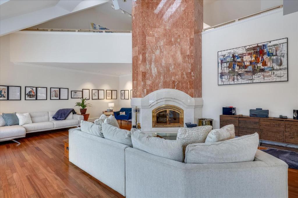 a living room with two couches and a fireplace at Edson Hill Estate in Stowe