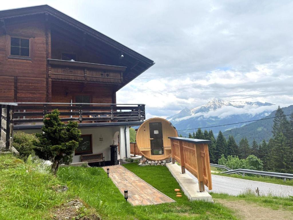 a large building with a porch and mountains in the background at Pargger in Hippach