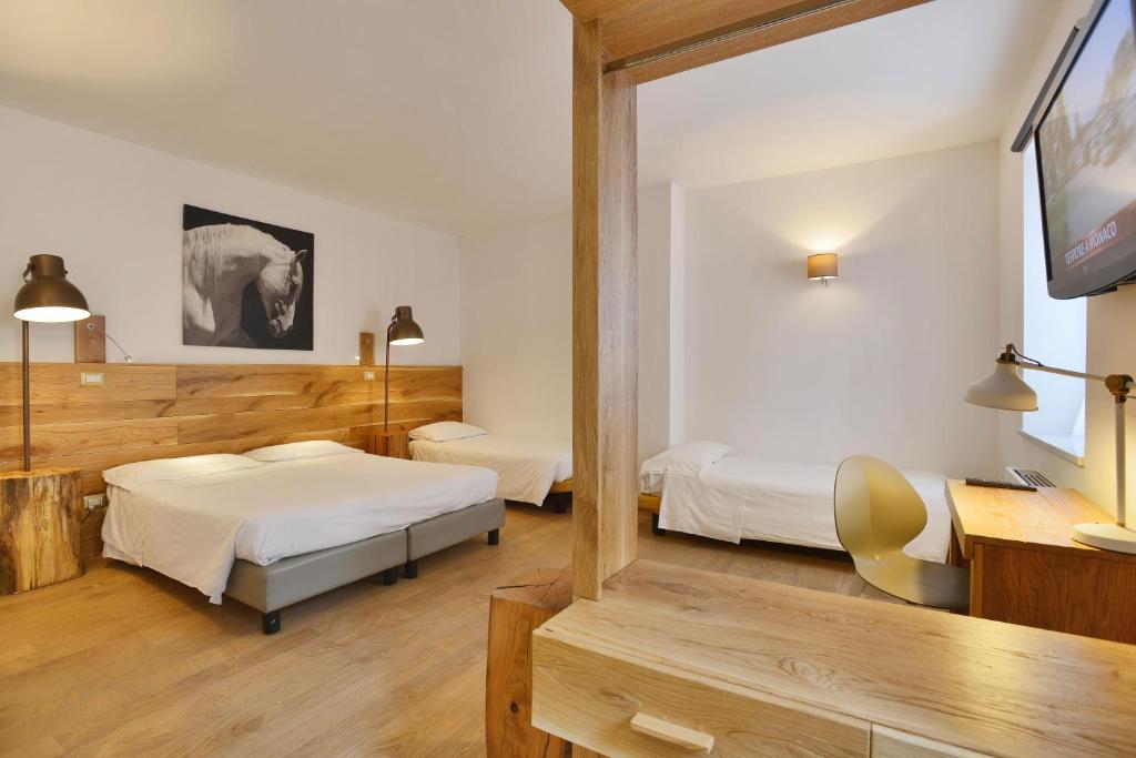 Postel nebo postele na pokoji v ubytování Albergo Les Dependances