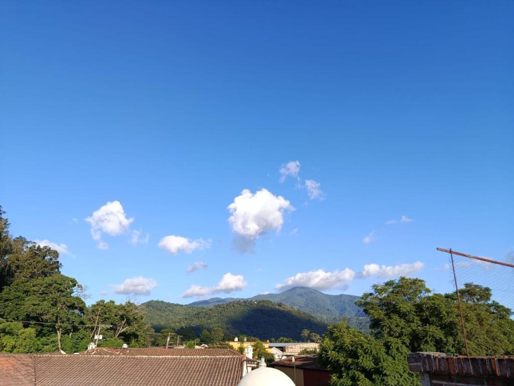 a view of the mountains from the roof of a house at Casa Feliz Antigua in Antigua Guatemala