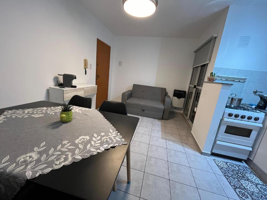 a kitchen and living room with a table and a couch at Urquiza tempo in Rosario