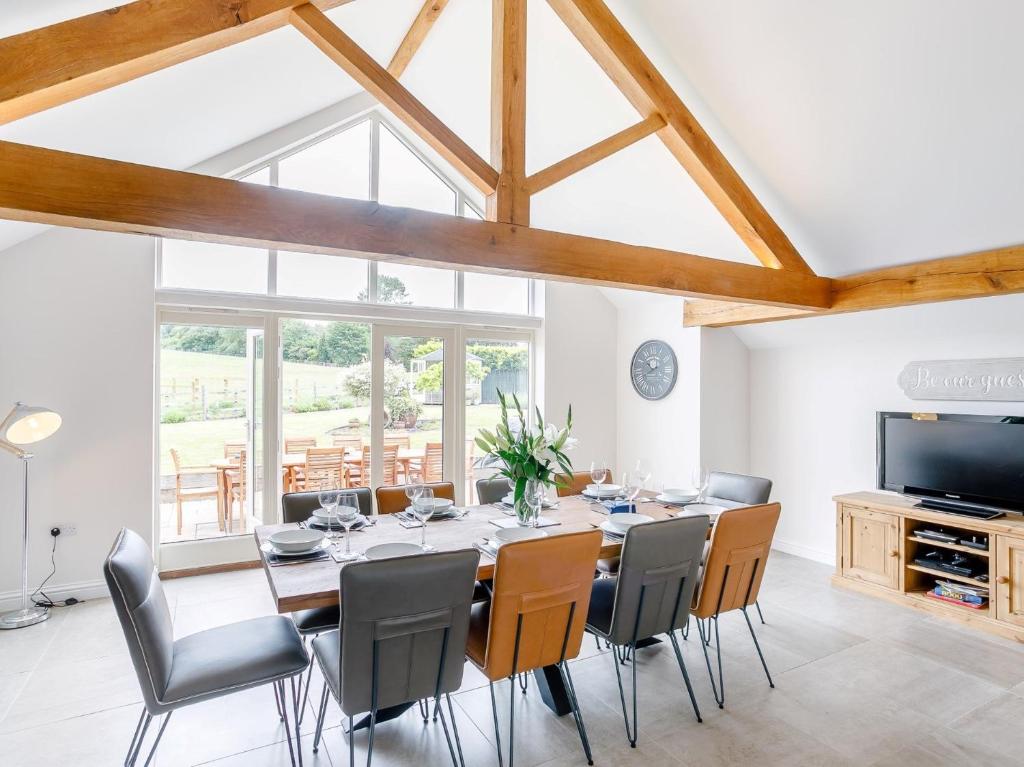 a dining room with a long table and chairs at 5 Bed in Tealby 78678 in Tealby