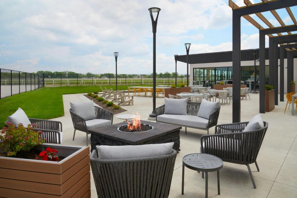 a patio with chairs and tables and a fire pit at TownePlace Suites by Marriott Columbus in Columbus