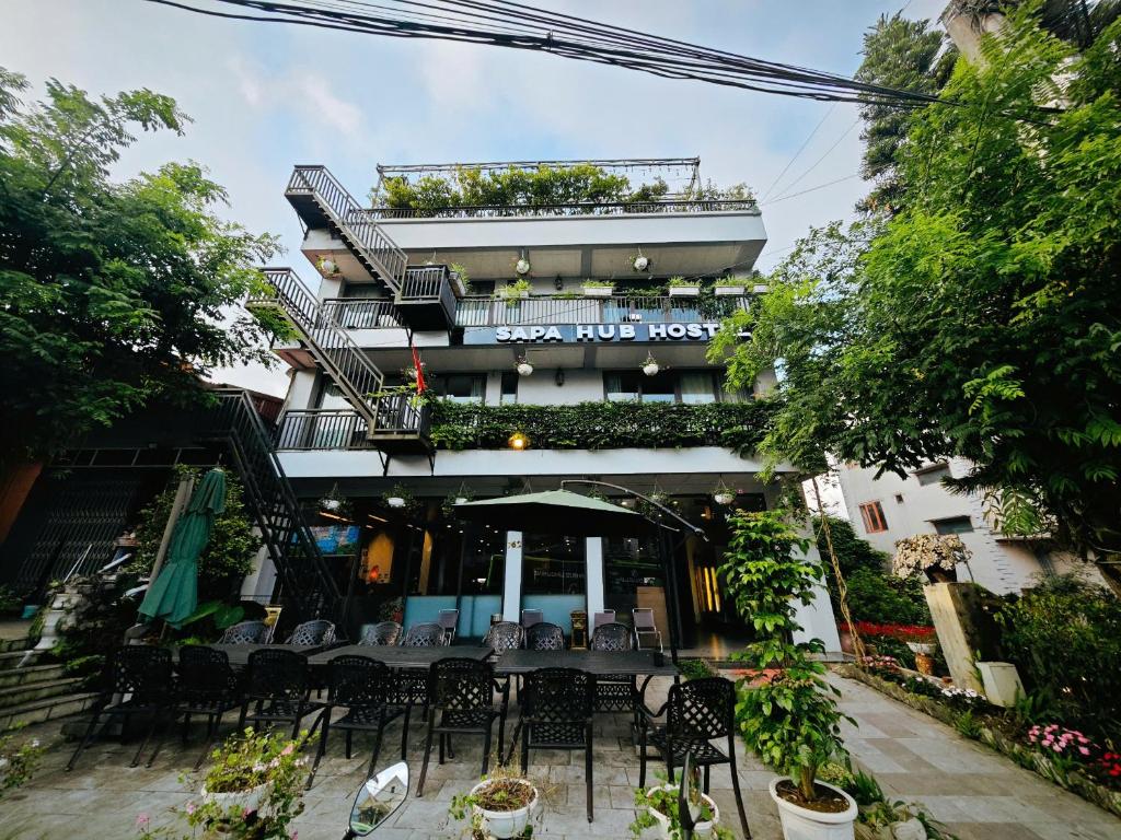 a restaurant with a table and chairs in front of a building at SAPA HUB hostel in Sa Pa