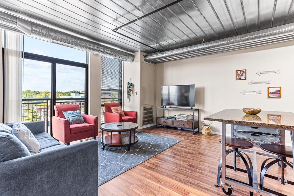 a living room with a couch and a table at 2 Combined Apartments near Kerrytown Concert House in Ann Arbor