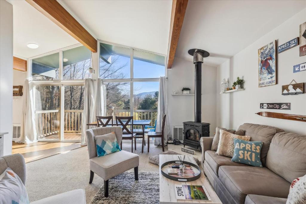 a living room with a couch and a fireplace at Mountainview Condo #2 in Stowe