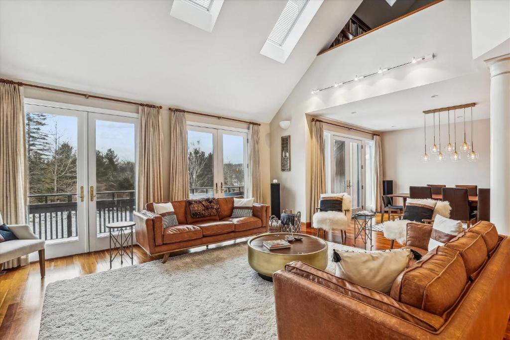 a living room with couches and a table at Stowe Haven in Stowe