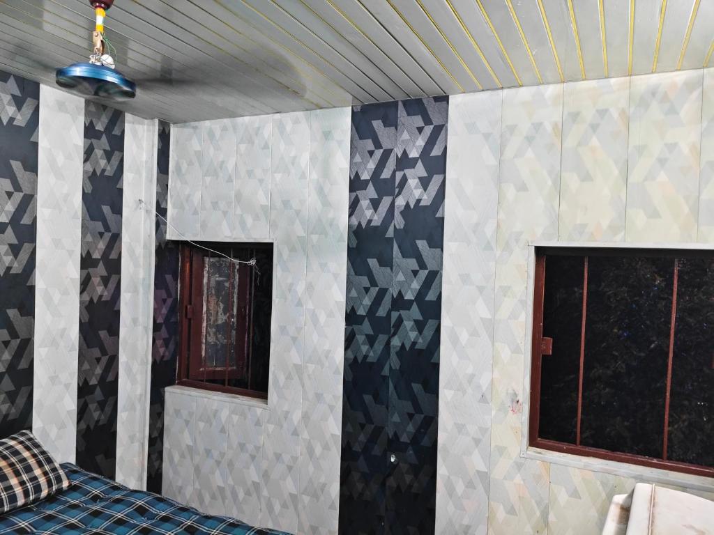 a room with blue and white walls and windows at City Guest house in Patna