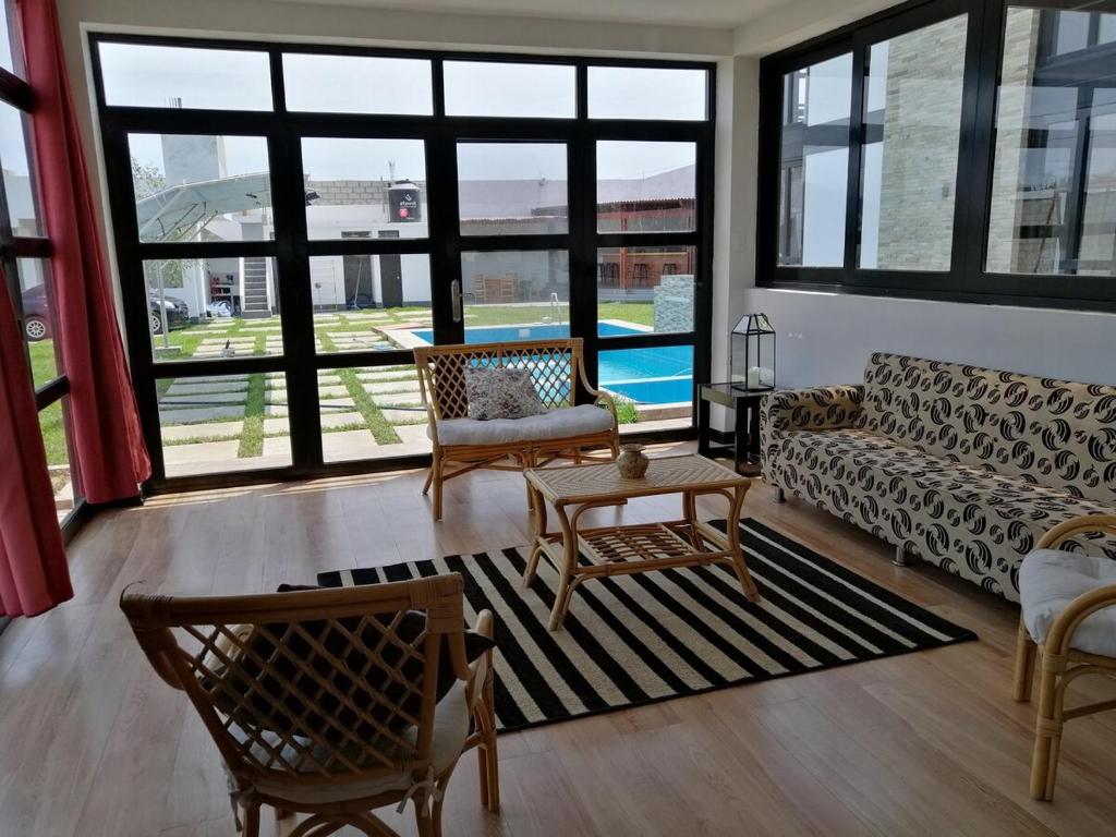a living room with a couch and a table at Vacation Home - Villa Konecta in Santiago de Cao