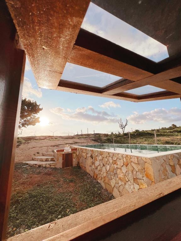 a view from the roof of a house with a stone wall at Casa Lajeiro in Serra de São Bento