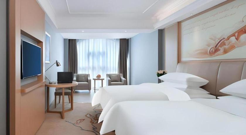 Postel nebo postele na pokoji v ubytování Vienna Hotel Anhui Xuancheng Langxi