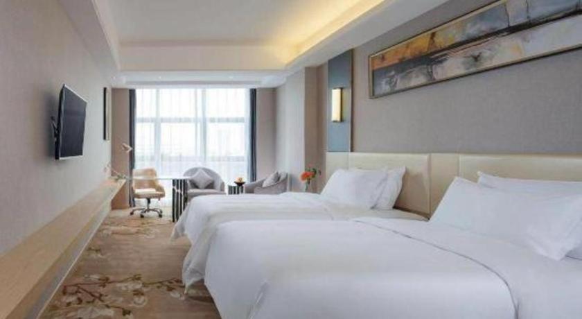 Postel nebo postele na pokoji v ubytování Vienna Hotel Guangdong Zhongshan Xiaolan High-Speed Railway Station