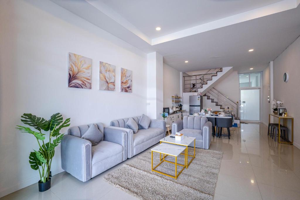 a living room with a couch and a table at Home Living 8 at Hat Yai - 3 mins to Shopping Mall in Ban Kohong