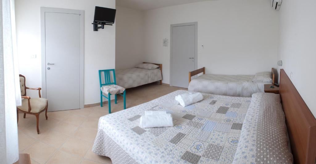 Postel nebo postele na pokoji v ubytování Hotel Elisabetta