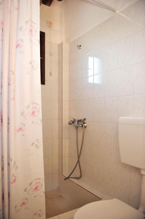 a bathroom with a shower with a toilet at Villa Anna Maria in Agia Paraskevi