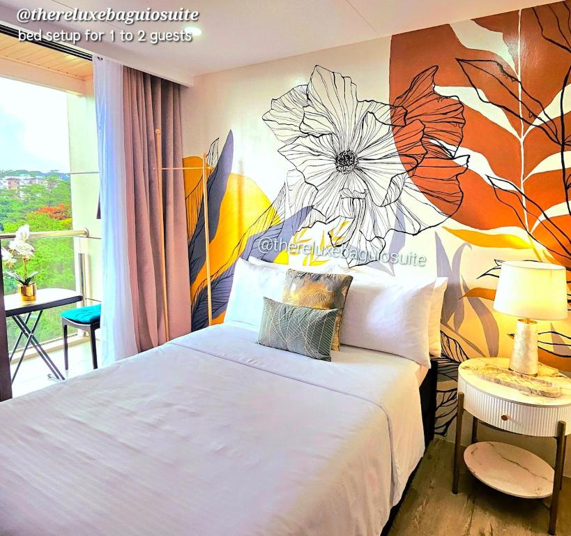 a bedroom with a bed with a flower mural on the wall at The ReLuxe Baguio Suite CityHub in Baguio