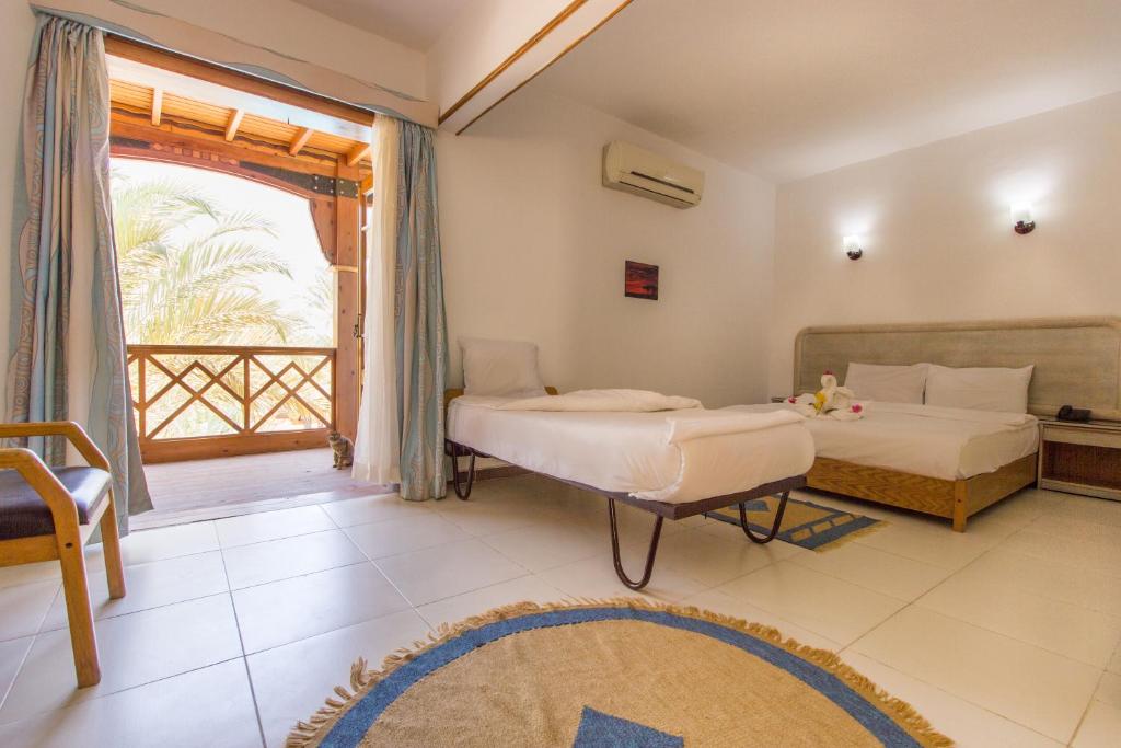 Postel nebo postele na pokoji v ubytování Acacia Dahab Hotel