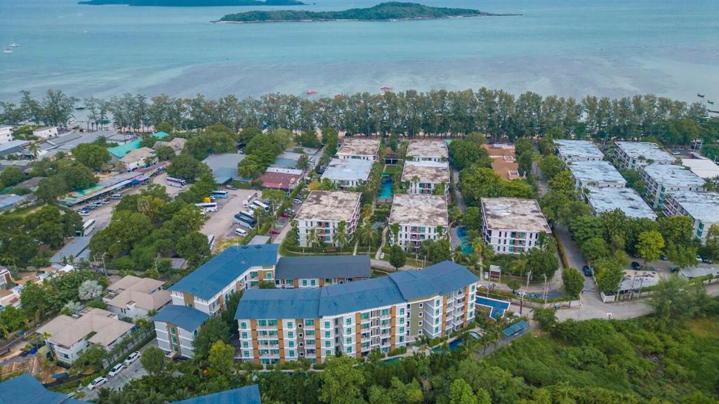 an aerial view of a resort with a parking lot at C222 Cozy 1BR Condo with Pool Access 500 m to Beach in Rawai Beach