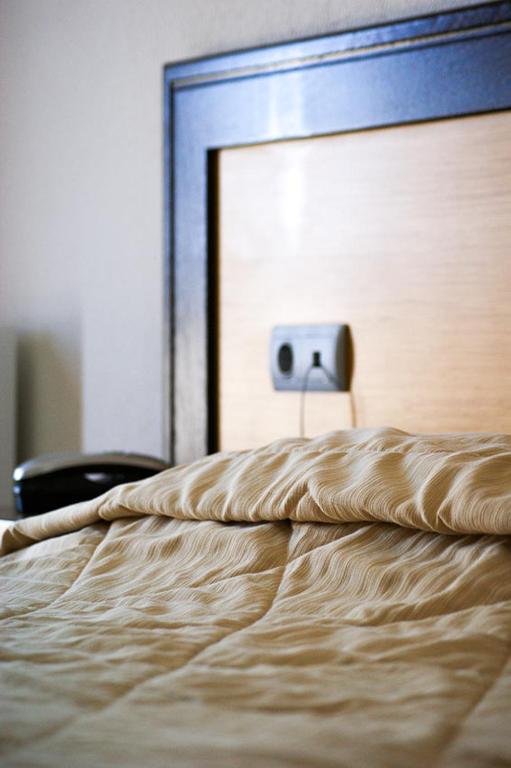Postel nebo postele na pokoji v ubytování Aposperides Hotel