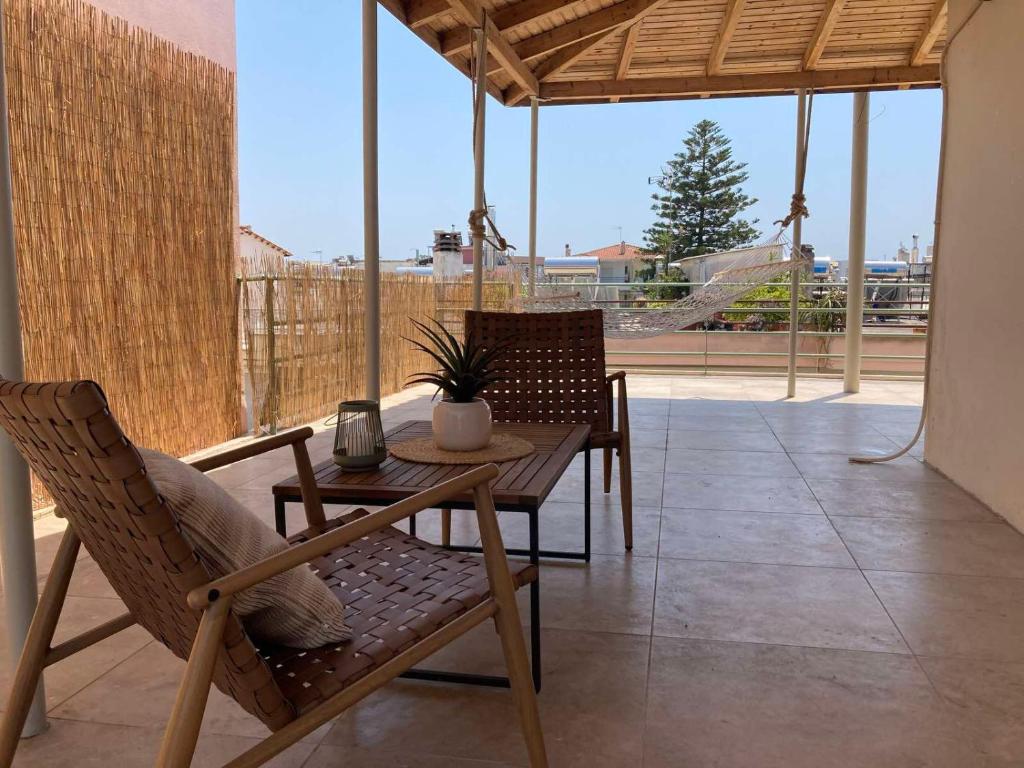 a table and chairs on a patio with a view at Star lounge in Preveza
