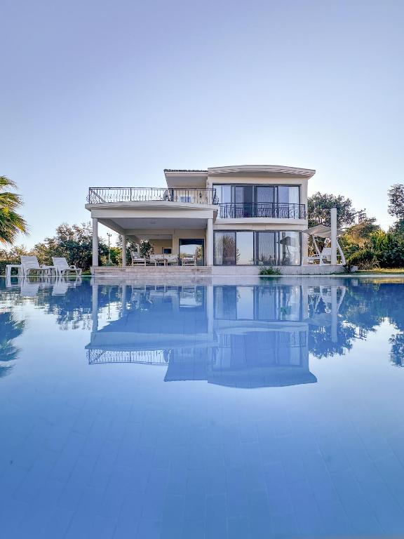 a house with a large pool in front of it at Urla Villa in Urla