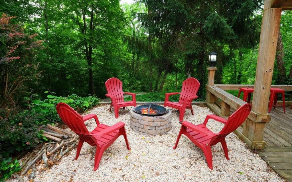 a group of red chairs around a fire pit at Whiskey Ridge in Sevierville
