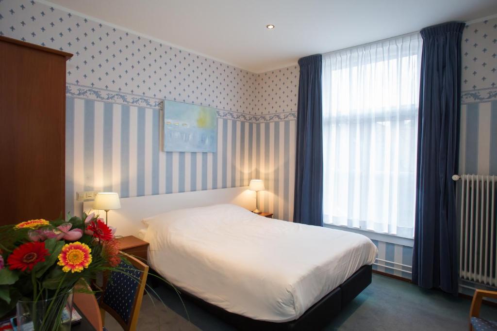 Postel nebo postele na pokoji v ubytování Landhotel De Hoofdige Boer