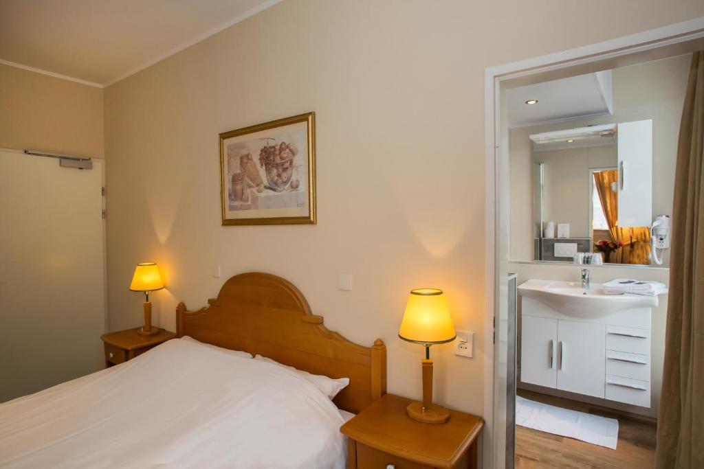 Postel nebo postele na pokoji v ubytování Landhotel De Hoofdige Boer