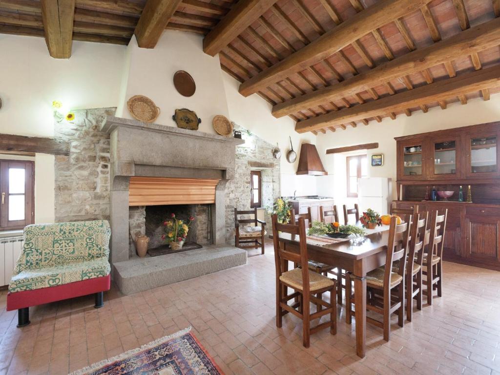 a living room with a table and a fireplace at Farmhouse in Apecchio with Swimming Pool, Terrace, Garden in Apecchio