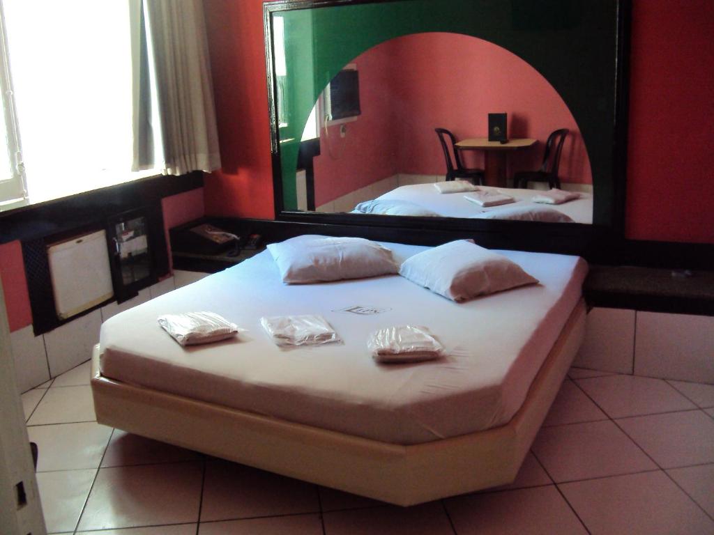 a bedroom with a bed with a large mirror at Lips Motel (Adult Only) in Rio de Janeiro