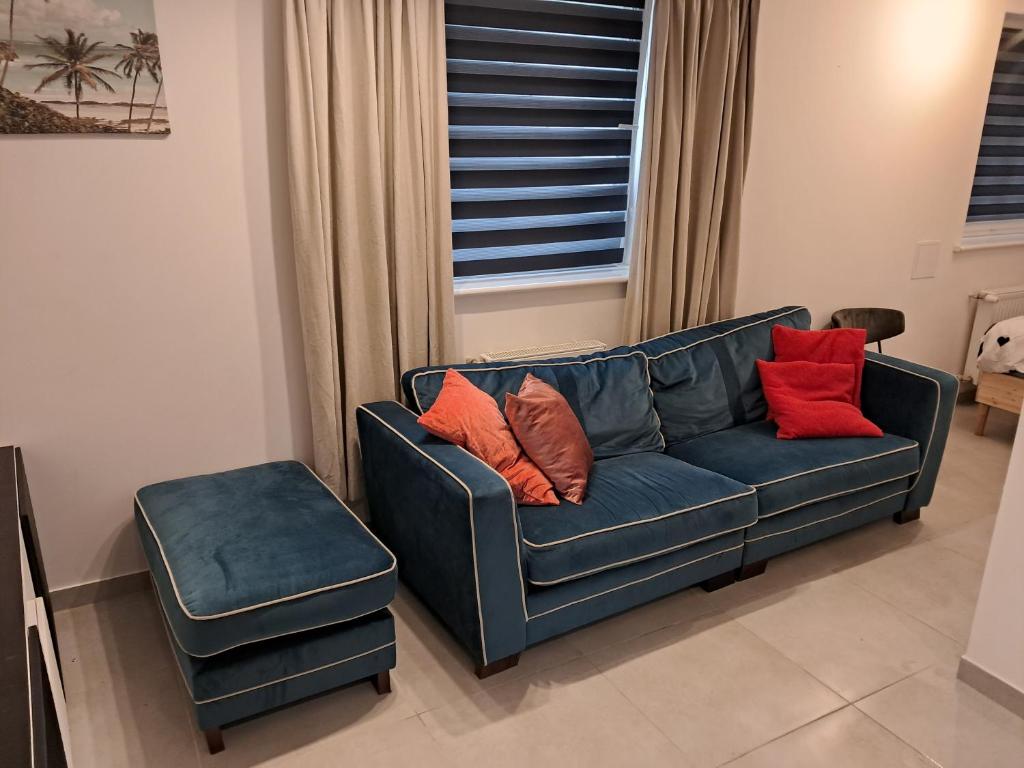 a blue couch and a stool in a living room at Kawalerka ul Wojska Polskiego in Skorka