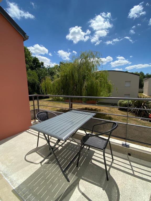 une table et des chaises assises sur un balcon dans l'établissement Appartement T2 Lamballe-Armor, à Lamballe Armor