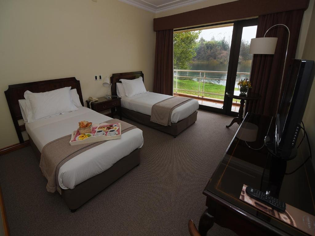 Postel nebo postele na pokoji v ubytování Hotel Naguilan