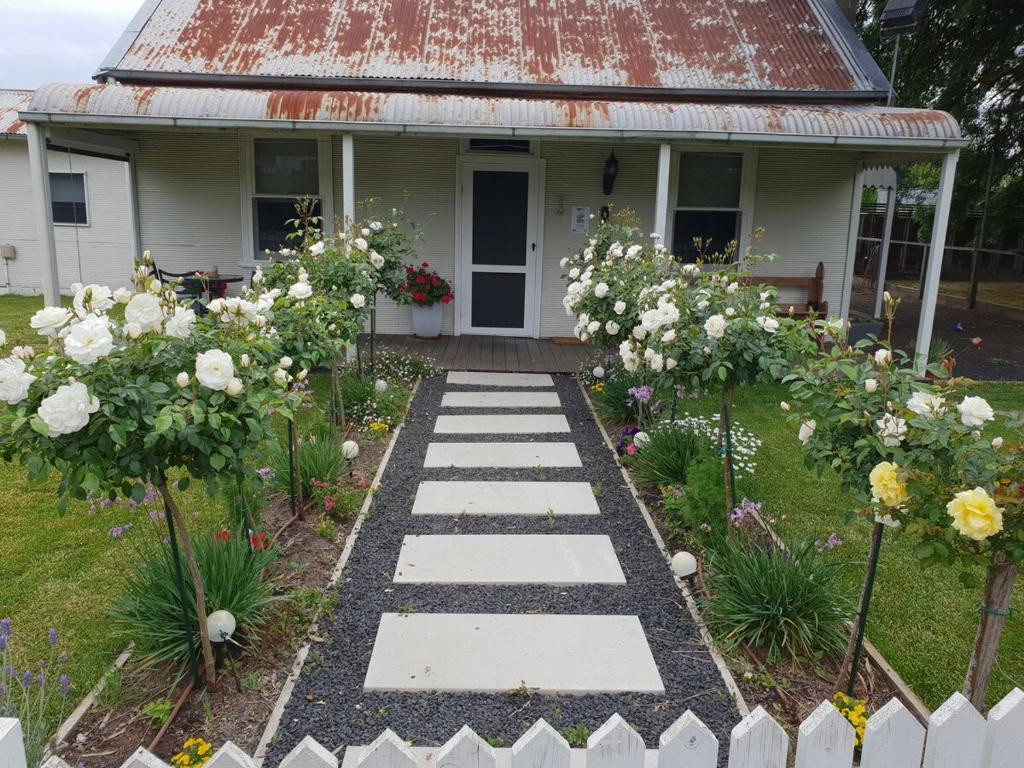 a garden with white flowers in front of a house at Yallamatta Bed and Breakfast in Apsley