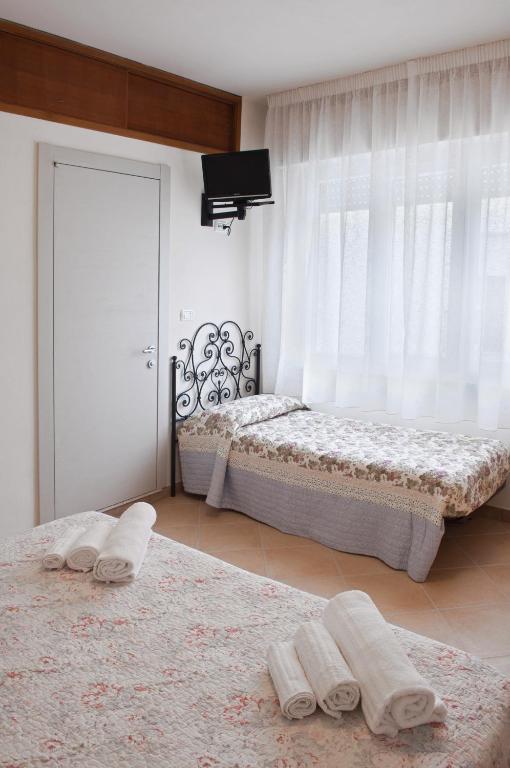 Postel nebo postele na pokoji v ubytování Hotel Elisabetta